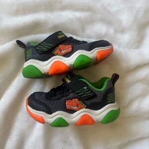 Skechers Kids Black Sneakers with Green & Orange Light-Up Soles Dino